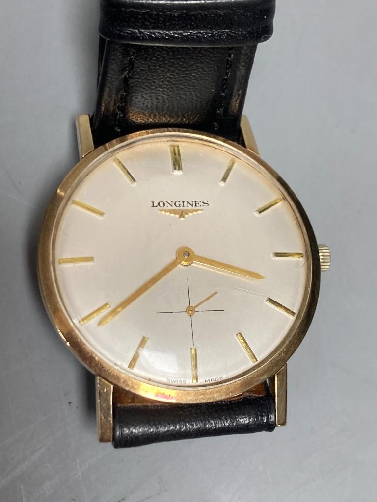 A gentleman's 1960's 9ct gold Longines manual wind wrist watch, on associated leather strap, case diameter ex. crown, 33mm, gross weight 24,4 grams.